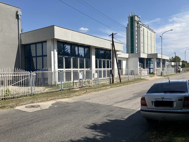 Commercial premises on 1.mája Street in Hurbanovo, white facade, parked car.