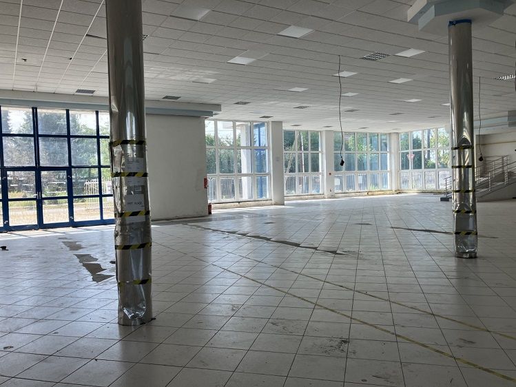 Bright commercial spaces with glass walls and tiling, ideal for various uses.