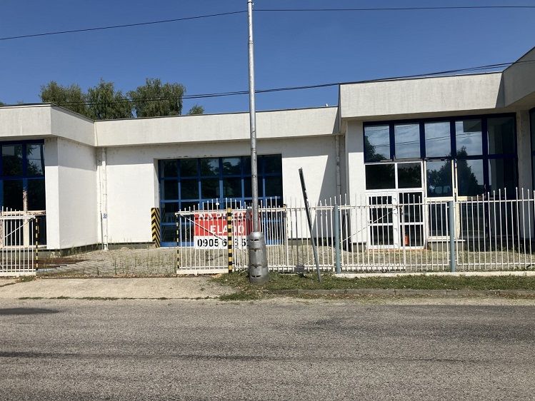 Commercial premises on 1. mája Street in Hurbanovo with a white facade and blue windows.