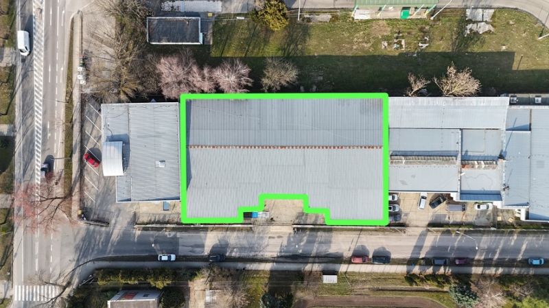 Commercial premises on 1. mája Street in Hurbanovo with a distinctive roof and adjacent greenery.