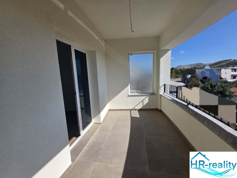 The balcony of a 2-room apartment in Žaborić with a view of the surroundings and a railing.