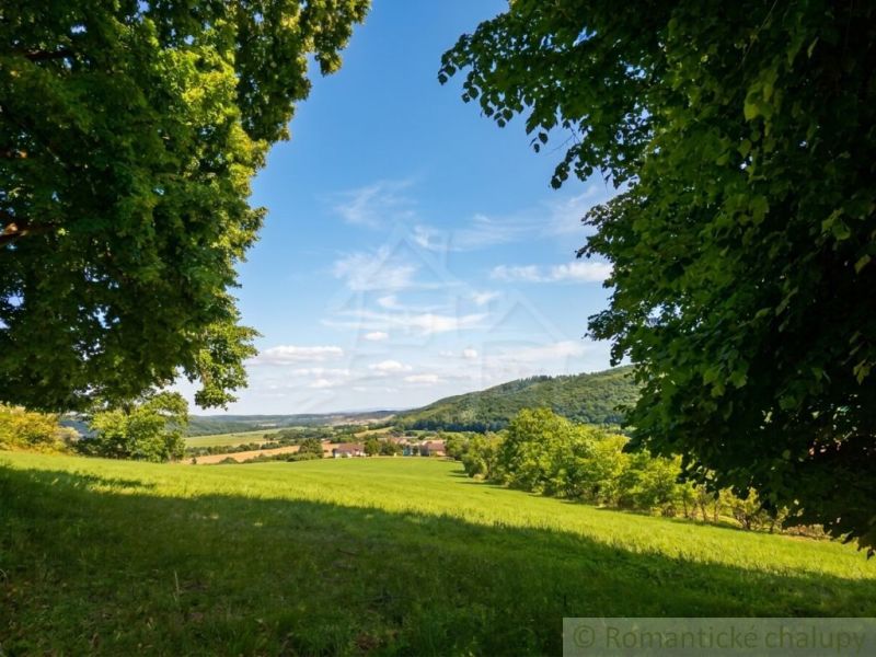A view of the landscape around Ozdín with meadows and hills.