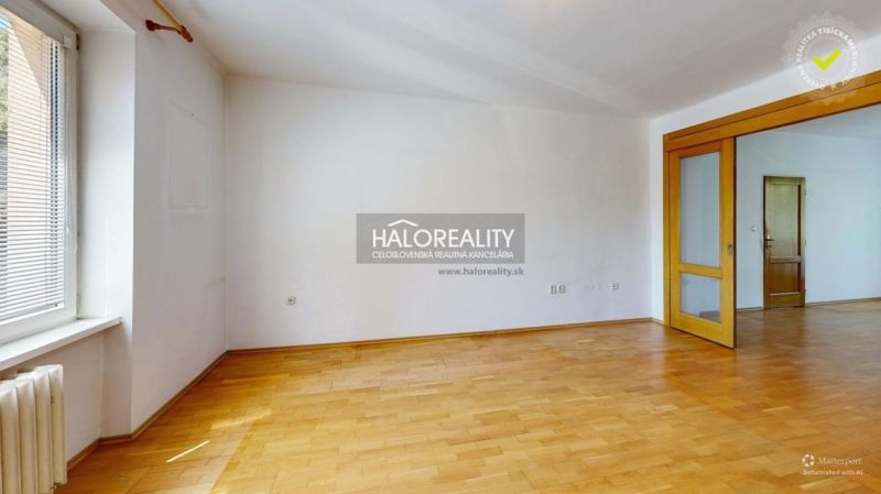 A spacious room with entrance doors and a wooden decor floor in a 3-room apartment.