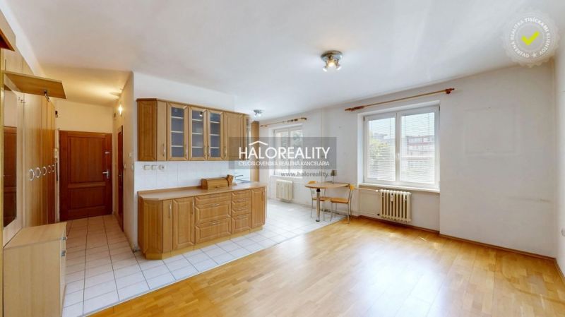 Kitchen corner with wooden kitchen cabinets in a 3-room apartment, floor with wooden decor.