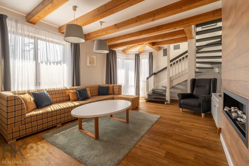 Living room in a 3-room apartment with a comfortable sofa and a wooden decor floor.