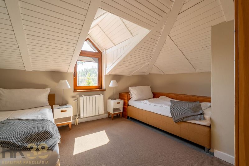Attic room with two beds and a view in a 3-room apartment.