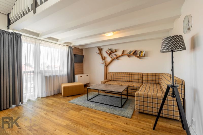 Living room in a 3-room apartment with a comfortable sofa and a wooden decor floor.