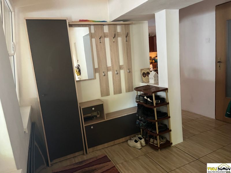 Hallway in a family house with a shoe cabinet and a mirror.
