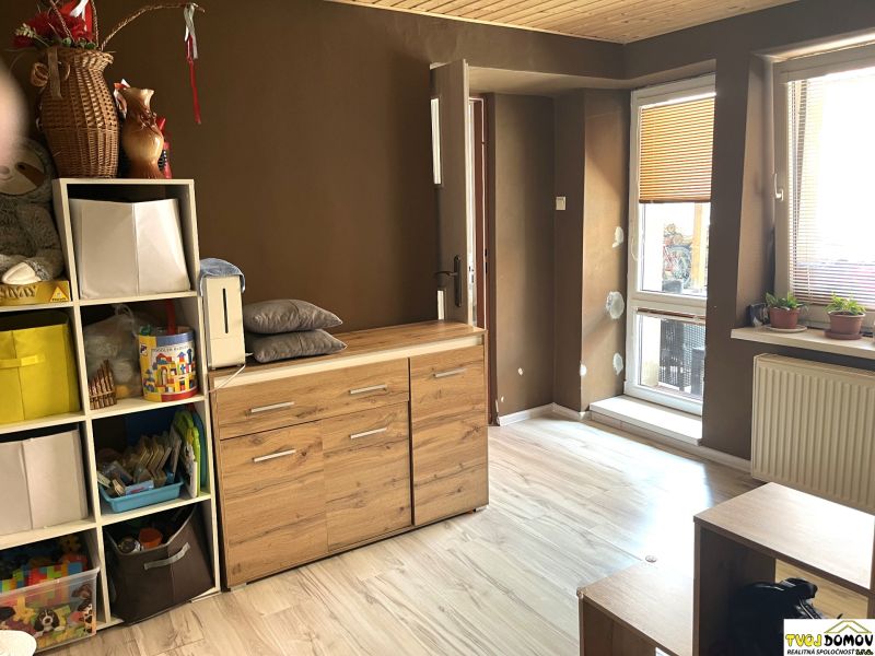 Interior of a family house with a shelving system and a wooden decor floor.