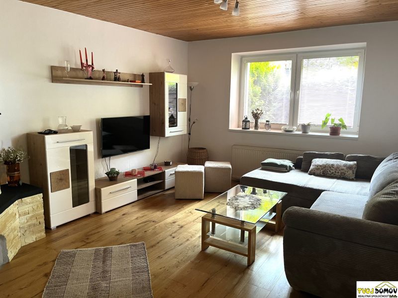 Living room in a family house with a sofa, cabinets, and a wooden decor floor.