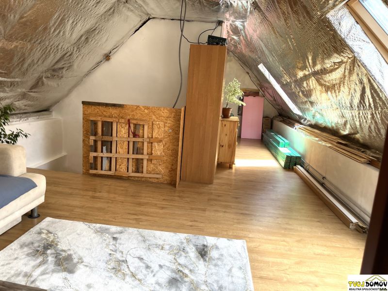 Attic room with wooden decor flooring in a family house.