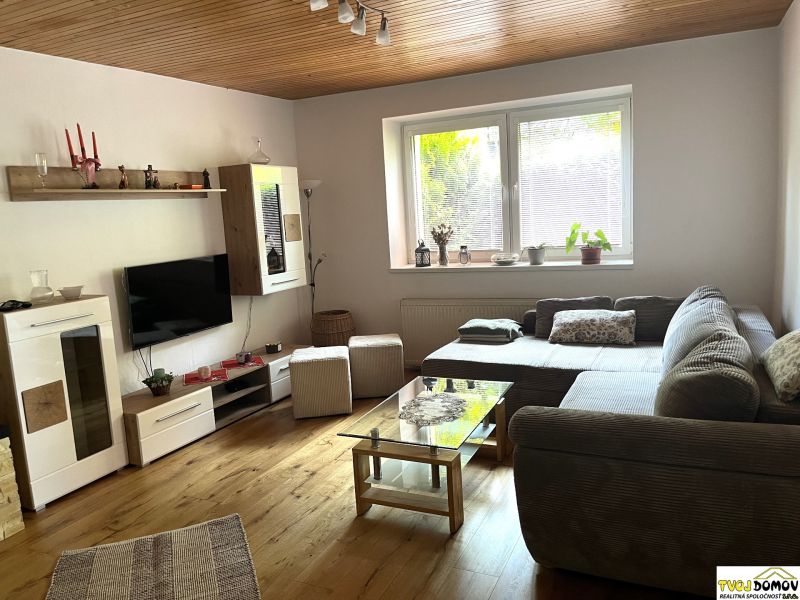 Living room in a family house with a wooden decor floor and a comfortable sofa.