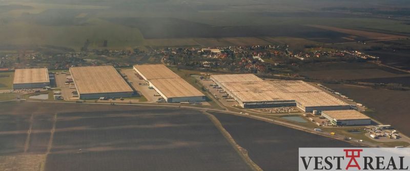 Aerial view of warehouses and halls in Galanta with the surrounding area of the village.