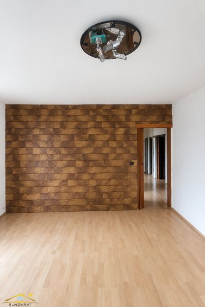 Interior of a 3-room apartment with a decorative wall and floor with a wooden decor.