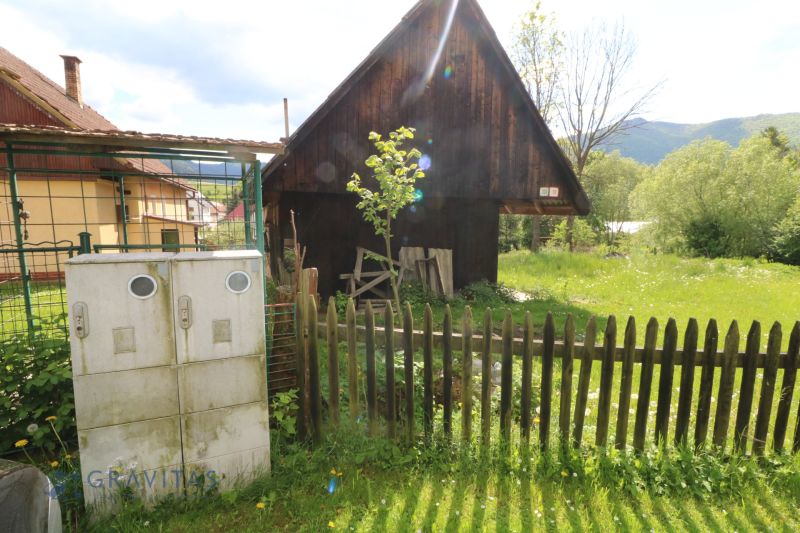 A wooden house in Žaškov on Matúšovská Street, surrounded by greenery and a fence. Construction of houses.