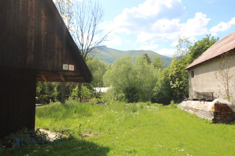 Žaškov, Matúšovská: Construction of houses surrounded by greenery, visible wooden and brick buildings.