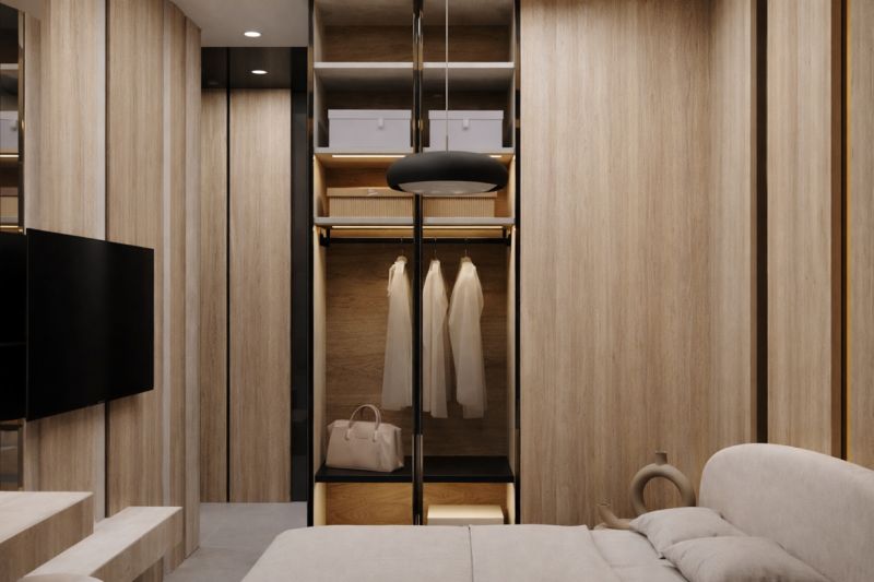 A wardrobe in a one-room apartment with a wood decor and open storage space.