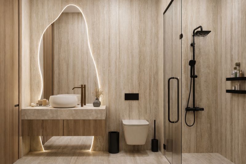 Bathroom with wood-patterned flooring, a sink, and a shower in a studio apartment.