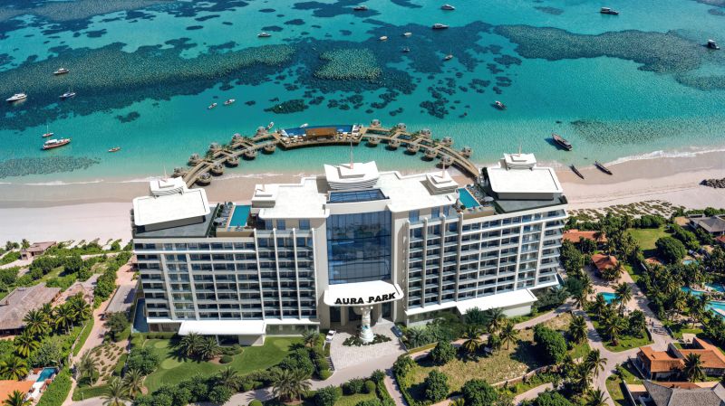 A hotel in Paje with a view of the turquoise sea and boats on the beach.