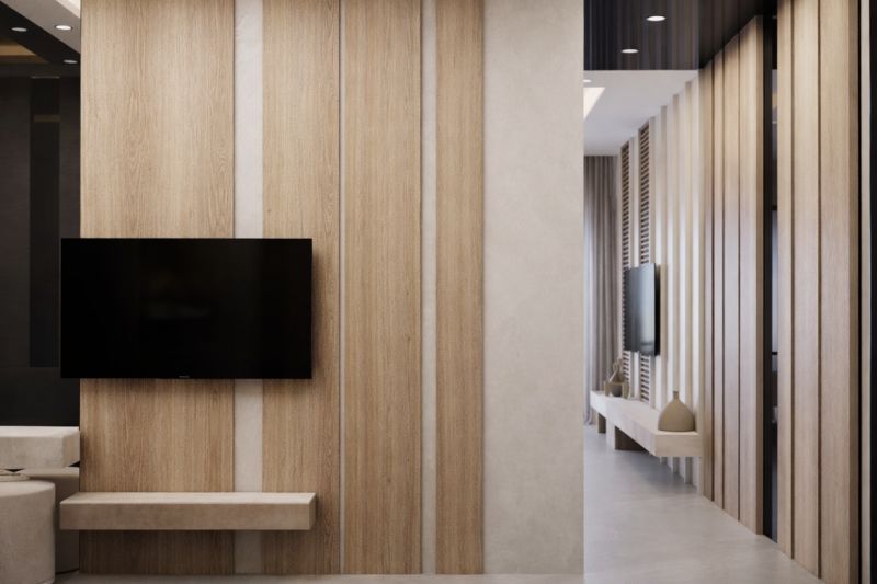 Interior wall with TV and decorative wooden element in a studio apartment.