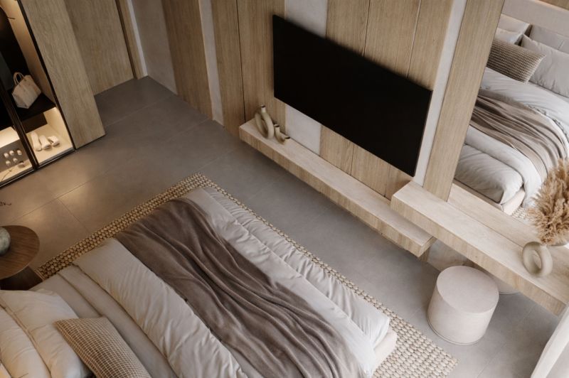 A bedroom in a two-room apartment with neutral tones and natural materials.