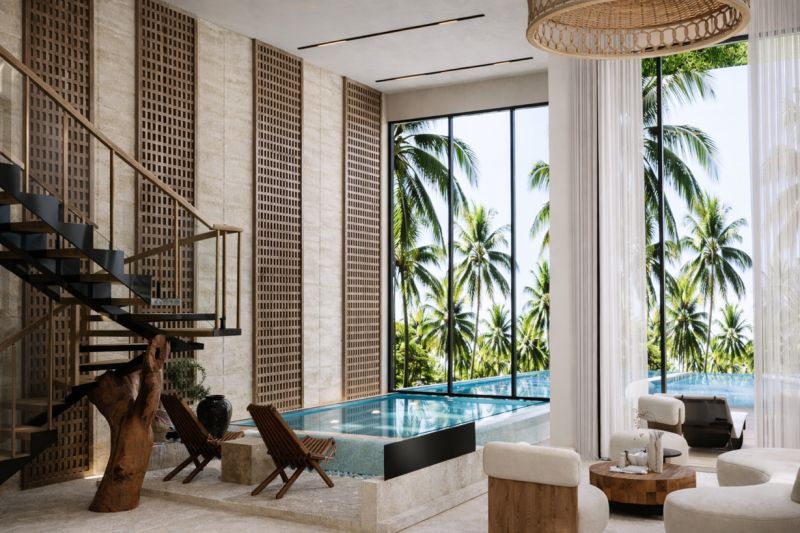 Interior of a 4-bedroom apartment with a pool, staircase, and view of palm trees in Paje.