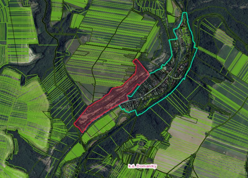 Aerial view of agricultural and forest lands around Domaníky.