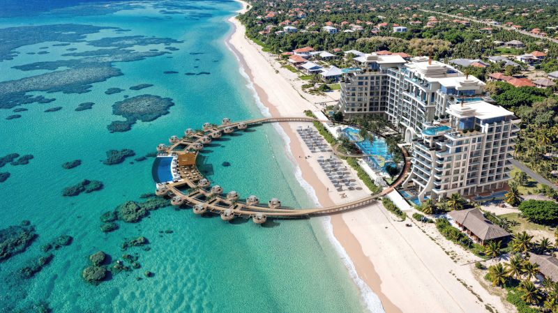 Beach resort by the turquoise sea with white sand and wooden villas in Paje.