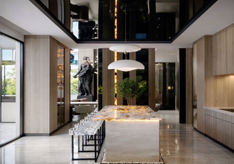A stylish kitchen with an impressive island and a wooden decor floor in a 5-room apartment.