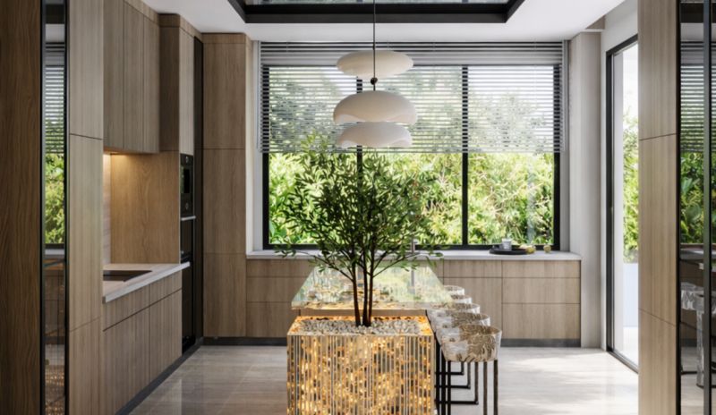 A kitchen in a large apartment with a window view, a central table, and lighting fixtures.