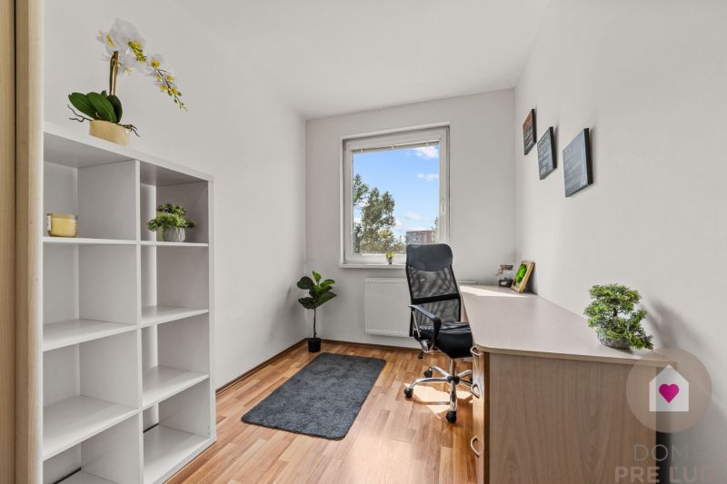 Office in a 4-room apartment with a desk, shelf, and floor with wooden decor.