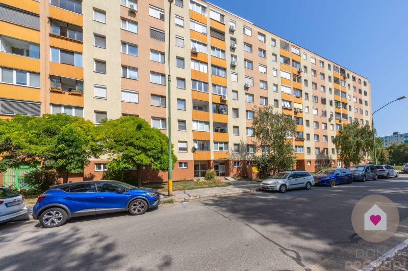 Apartment building on Švabinského Street in Bratislava - Petržalka with cars and greenery.