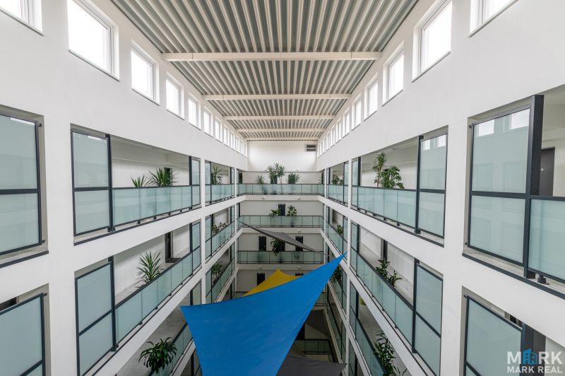 A device with glass railings and plants in the interior, ideal for a 2-room apartment.