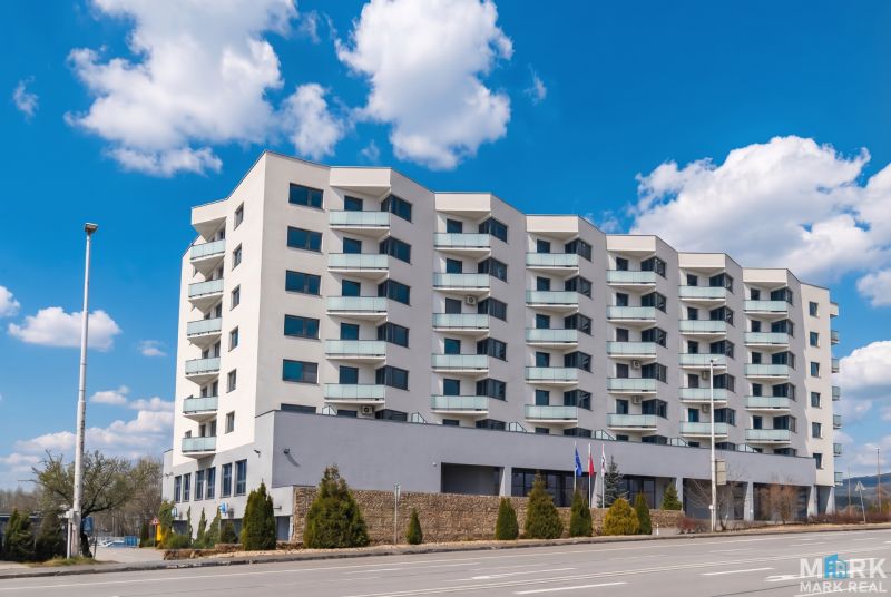 Apartment building on Rybničná Street in Bratislava - Vajnory with balconies and blue sky.
