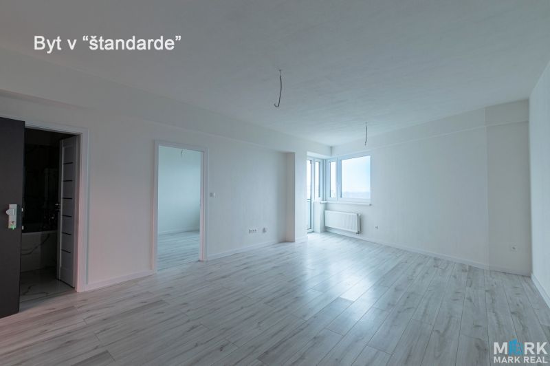Living room with wood-patterned flooring in a standard two-room apartment.
