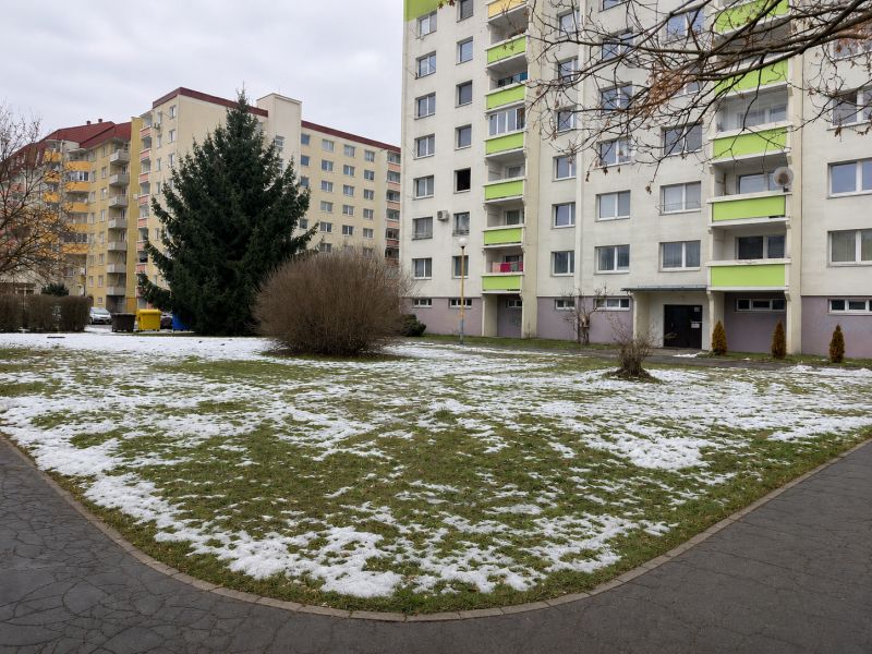 Apartment buildings surrounded by remnants of snow on Novozámocká Street, Zvolen, Banská Bystrica Region, Slovakia.