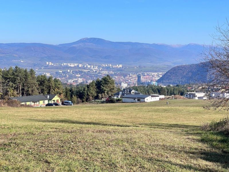 Panorama of Banská Bystrica from the Pršianska road, Residential plots, with a mountain backdrop.