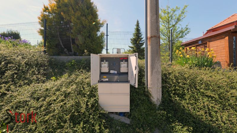 An open electrical cabinet among the greenery in Lietavská Svinná-Babkov for residential plots.