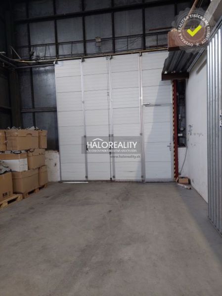 In warehouses and halls, there are pallets with boxes and large white doors.