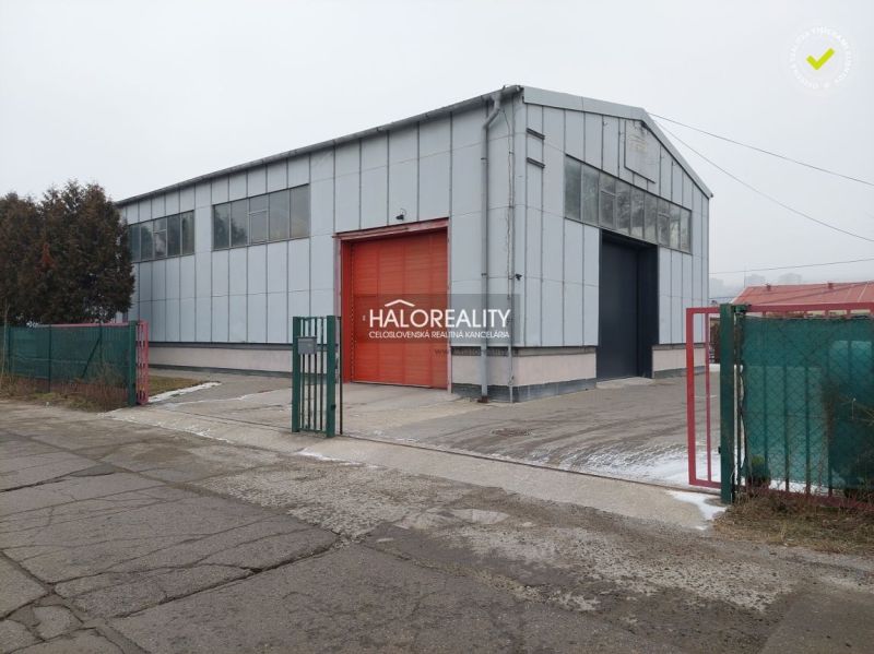 Warehouses and halls in the district of KE - Džungľa, with a metal structure and a red gate.