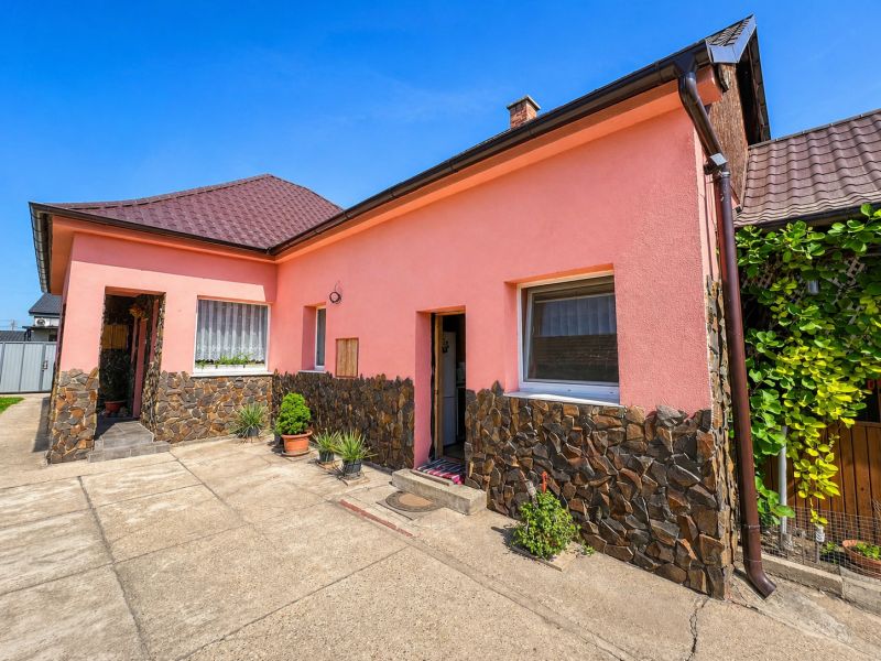 Pink family house on Nova Cesta in Jelka, Galanta district, clad in stone.