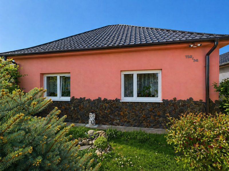 The family house on Nova Cesta in Jelka, Galanta district, has a pink facade and a tiled roof.