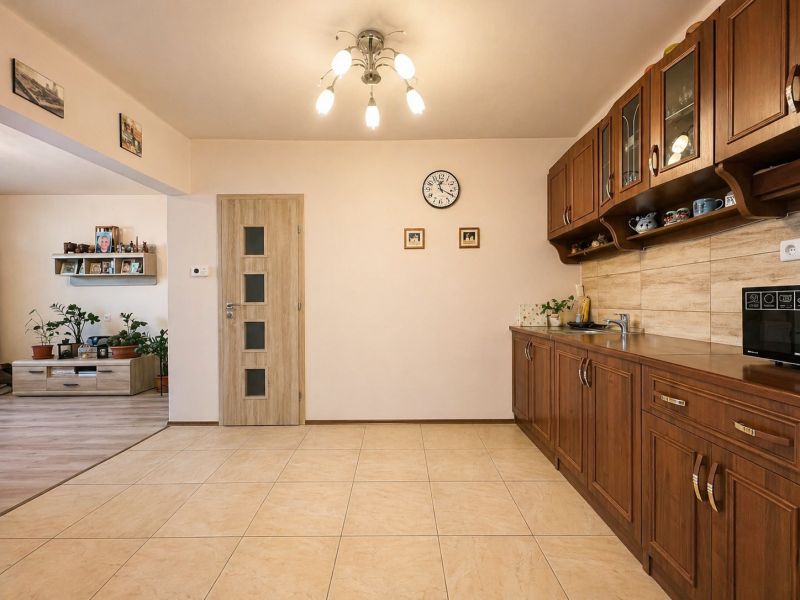 A kitchen with brown cabinets and ceramic flooring, Family house.