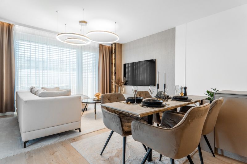 Living area with a dining table and a wooden decor floor in a 3-room apartment.