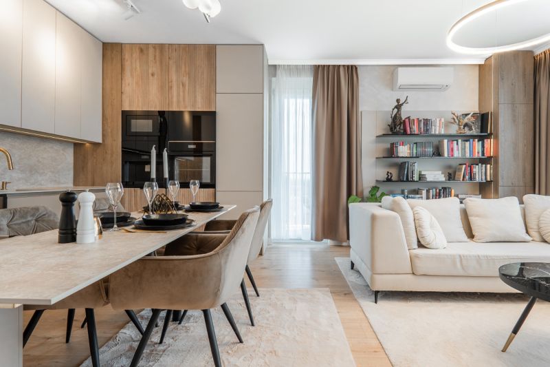 Open-plan three-room apartment with a kitchen, dining table, and comfortable living area.