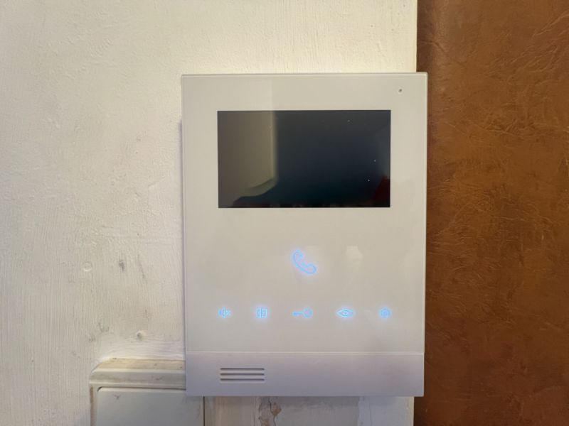 Interior touch panel with display, likely for a video intercom in a 2-room apartment.