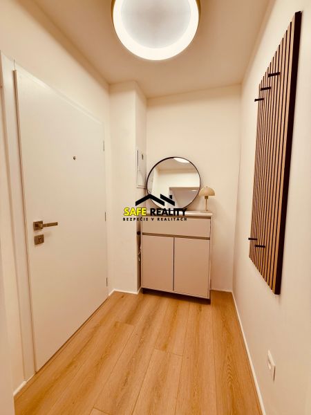 A hallway in a 3-room apartment with a wooden decor floor and modern lighting.