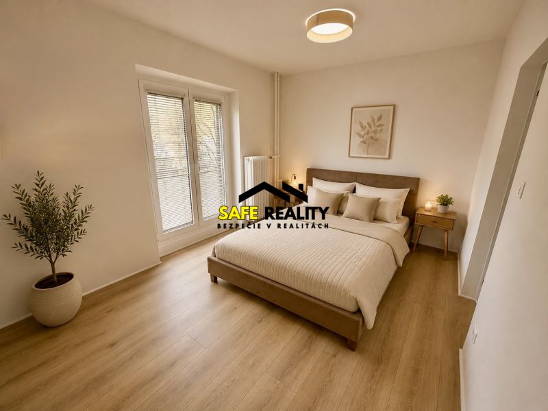 A bedroom in a 3-room apartment with a wooden decor floor and a potted plant.