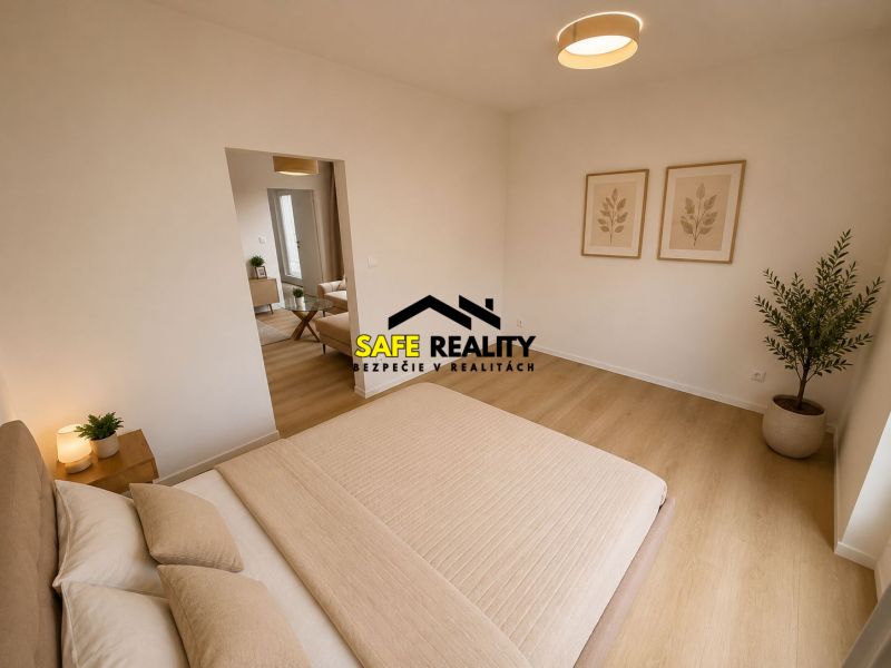 A bright bedroom with a bed, decorations, and a wood-patterned floor in a three-room apartment.