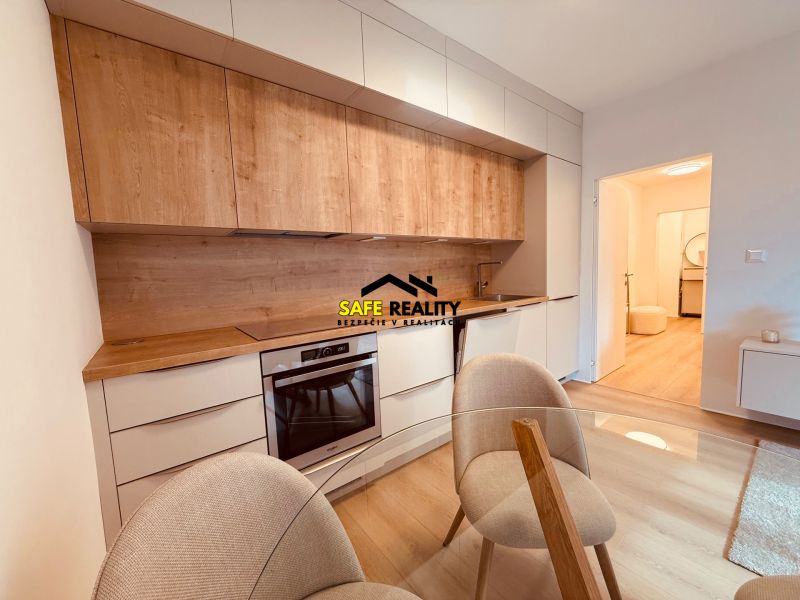 A kitchen in a 3-room apartment with a wood-decor floor and a built-in unit.